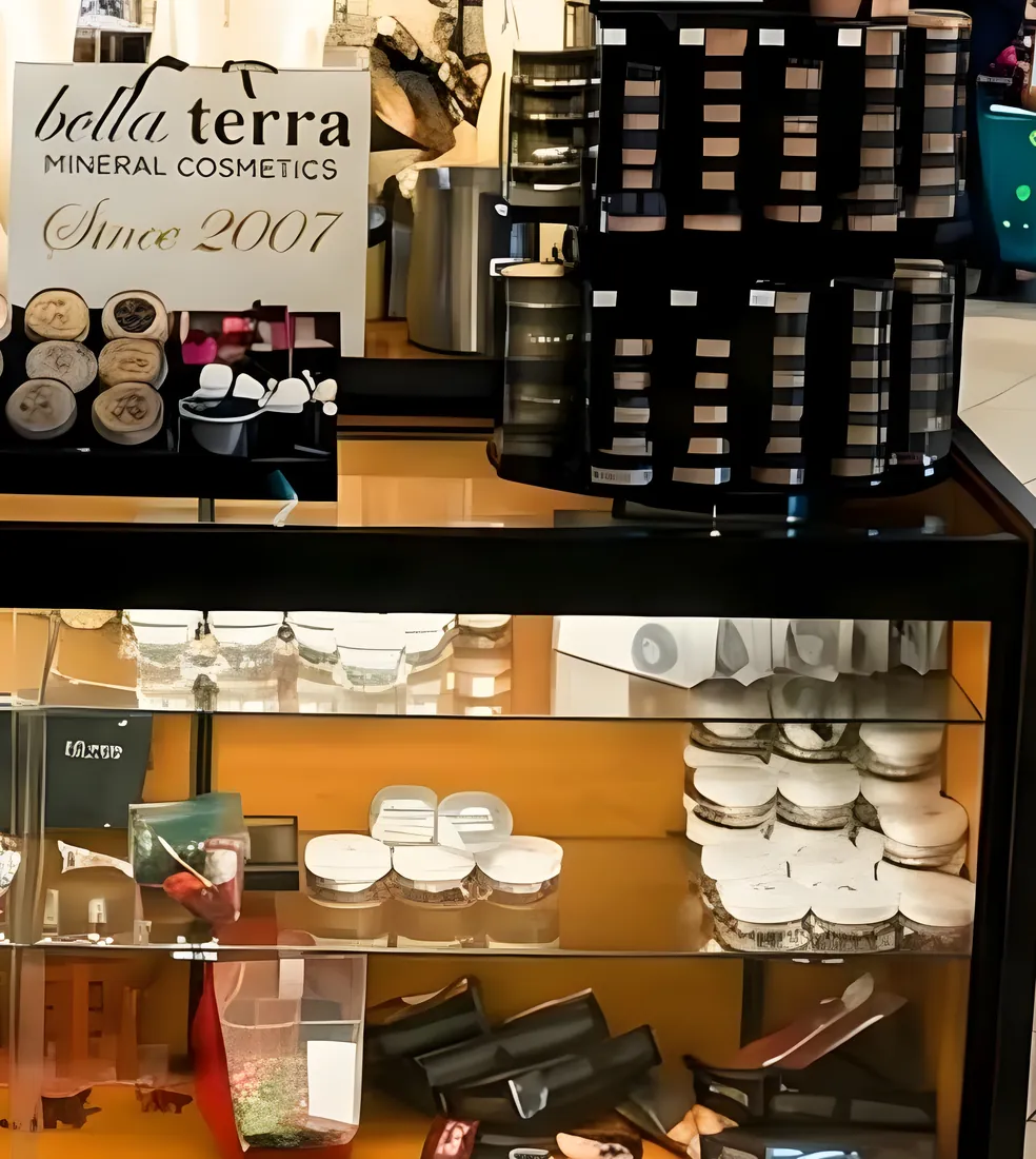A BELLATERRA kiosk counter with mineral foundation jars and brushes
