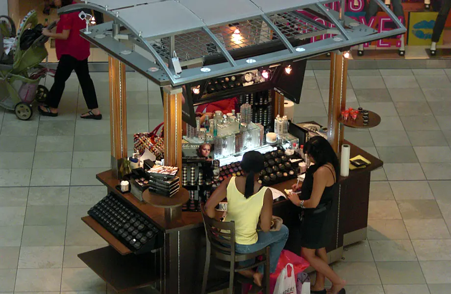 Shoppers getting their makeup done at a BELLATERRA kiosk, 2008