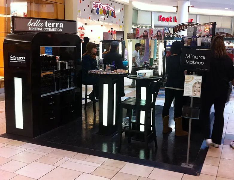 BELLATERRA mineral cosmetics kiosk in a shopping mall with shoppers, 2010